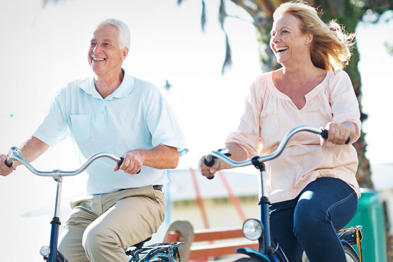 Elderly couple riding bicycles